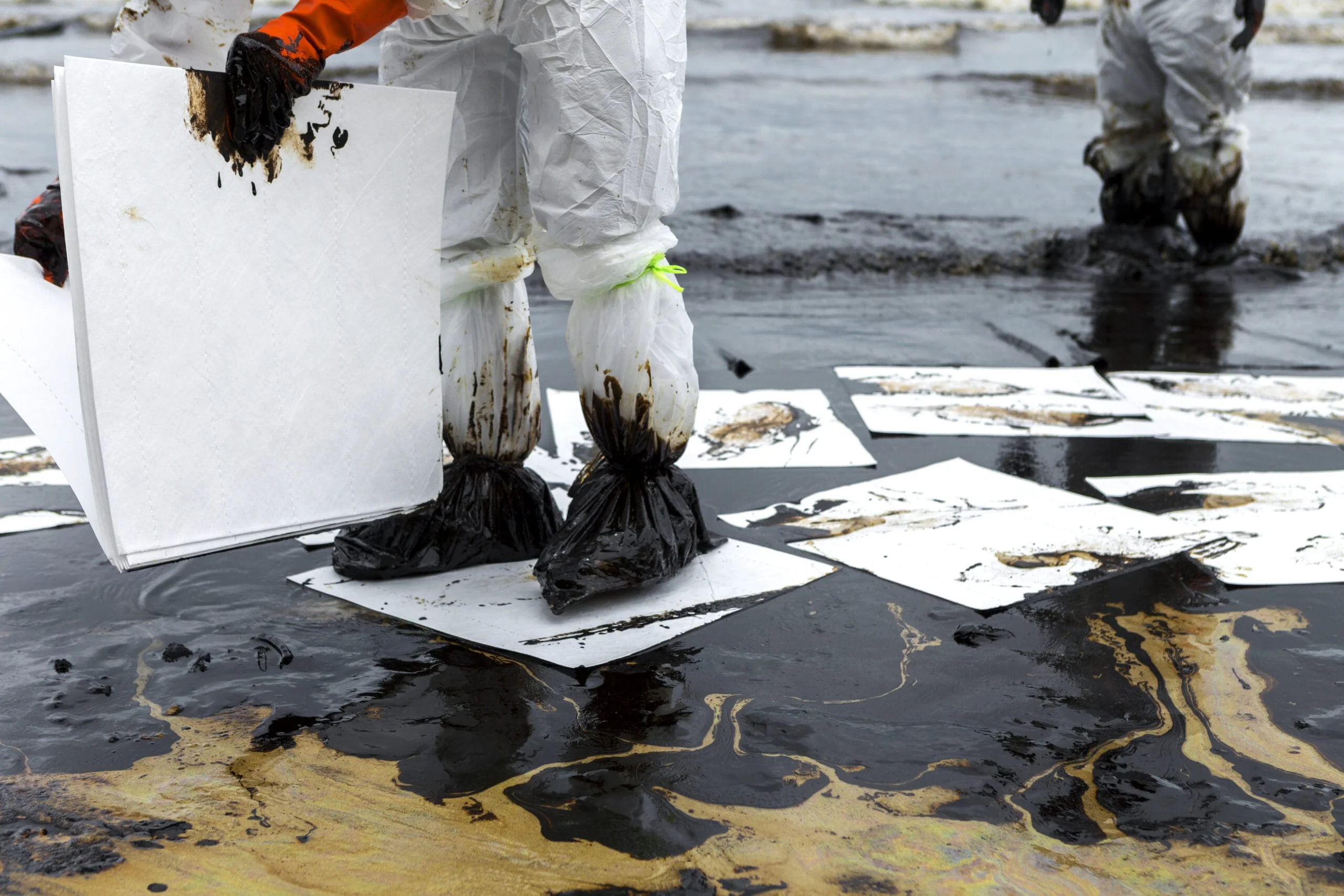 Workers Remove And Clean Up Crude Oil Spilled With Absorbent Sheets