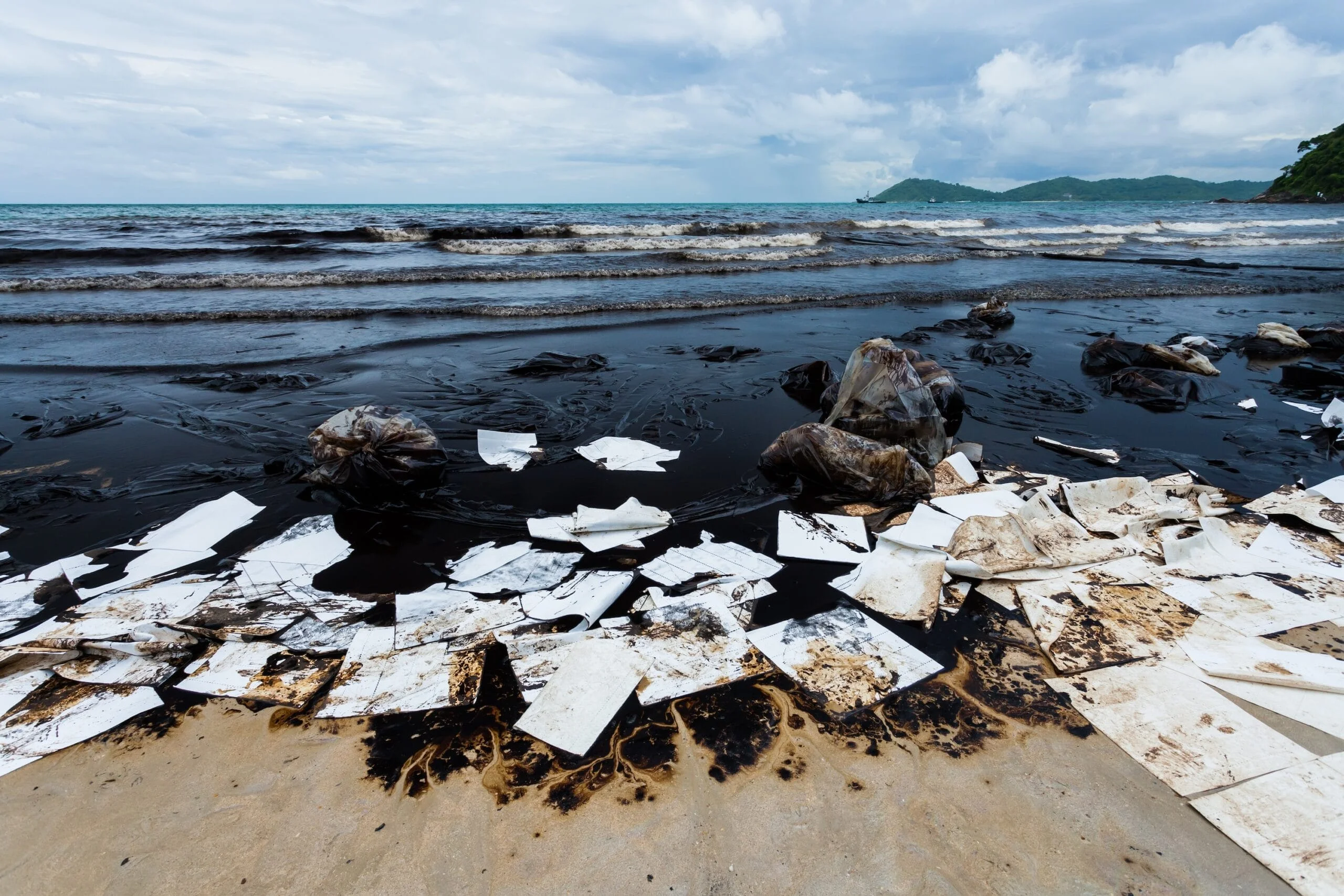 Ao Prao Beach was full of crude oil and absorb paper on oil spill accident on Ao Prao Beach at Samet island on July 31,2013 in Rayong,Thailand